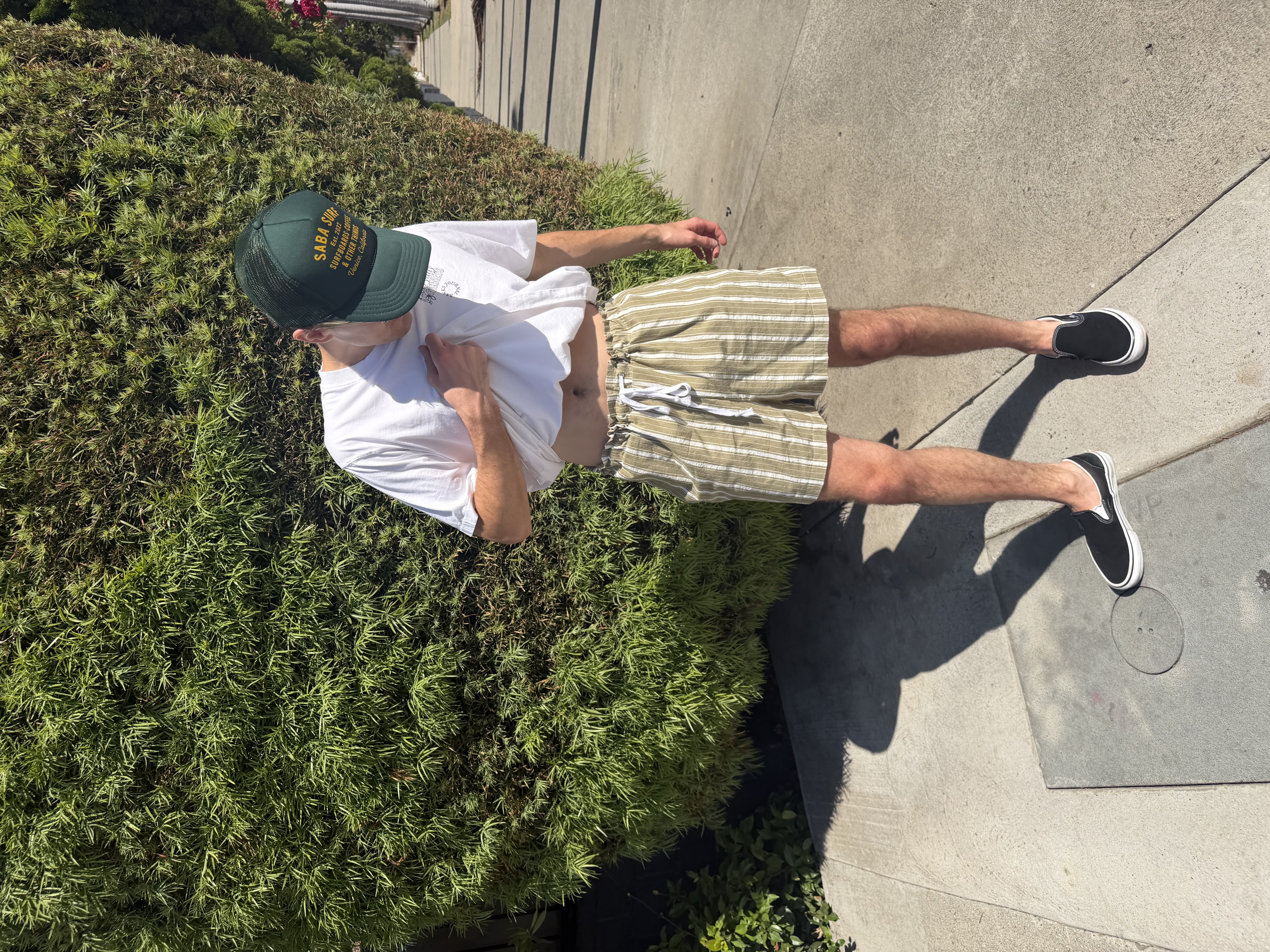 Chris lifting his shirt to show off the finished shorts and drawstring